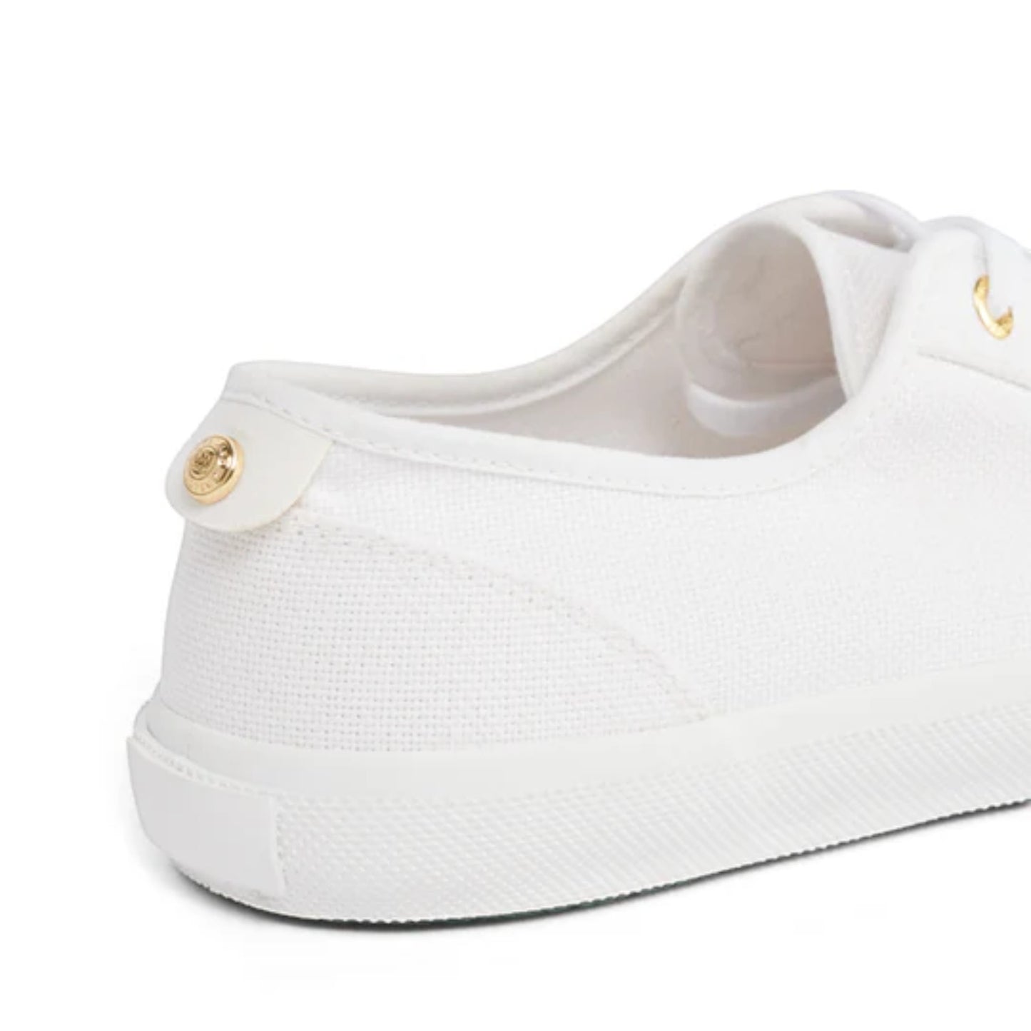 White sneaker with a gold accent on a white background