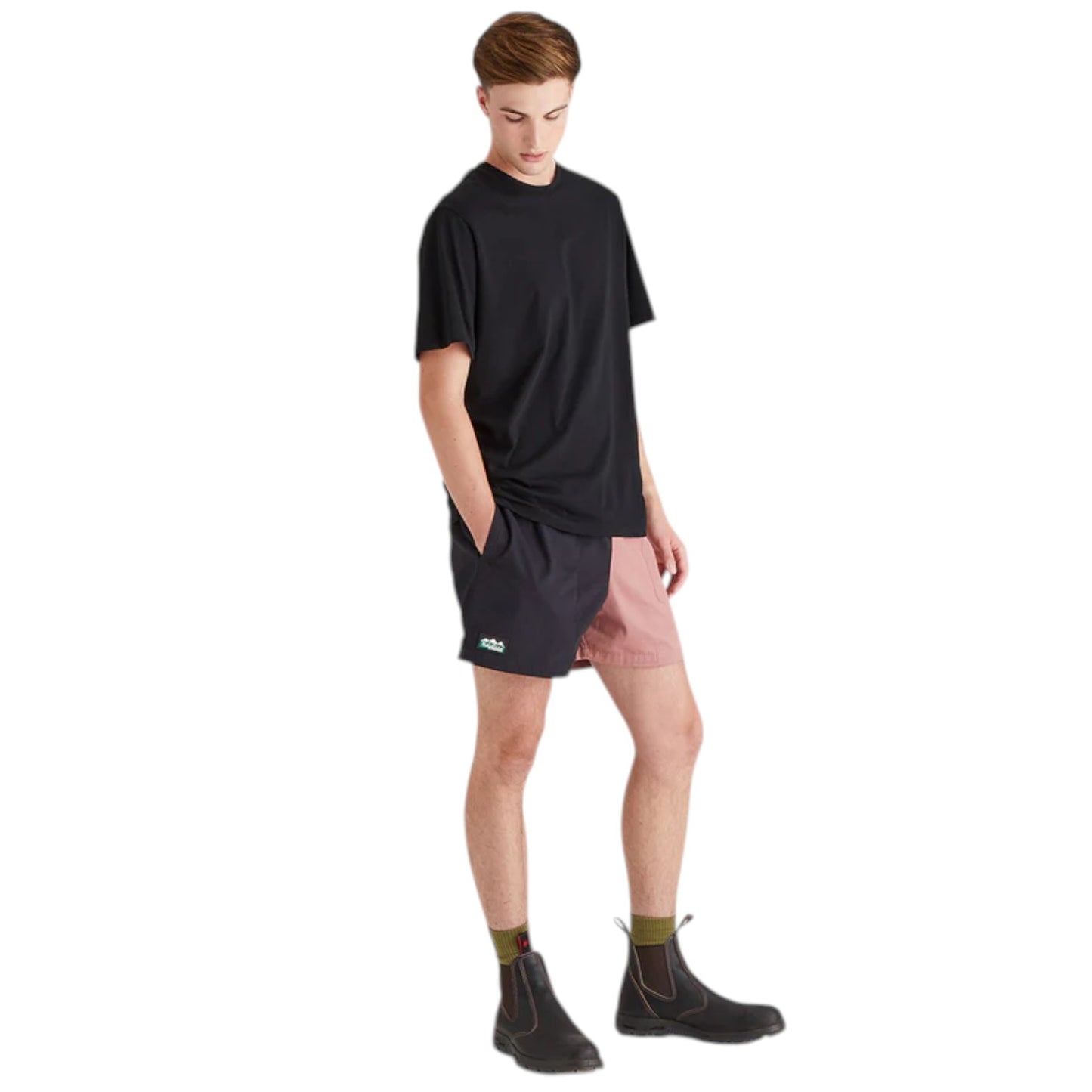 Person wearing a black t-shirt, black shorts, and black shoes on a white background