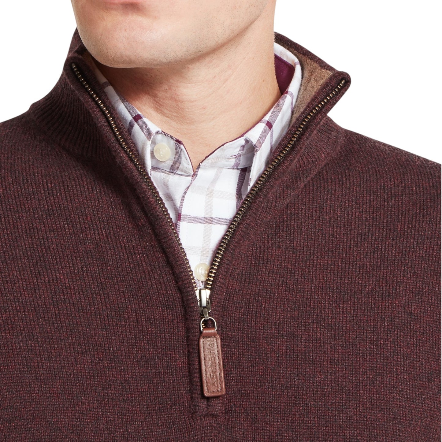 Close-up of a brown zip-up sweater with a plaid shirt underneath on a white background