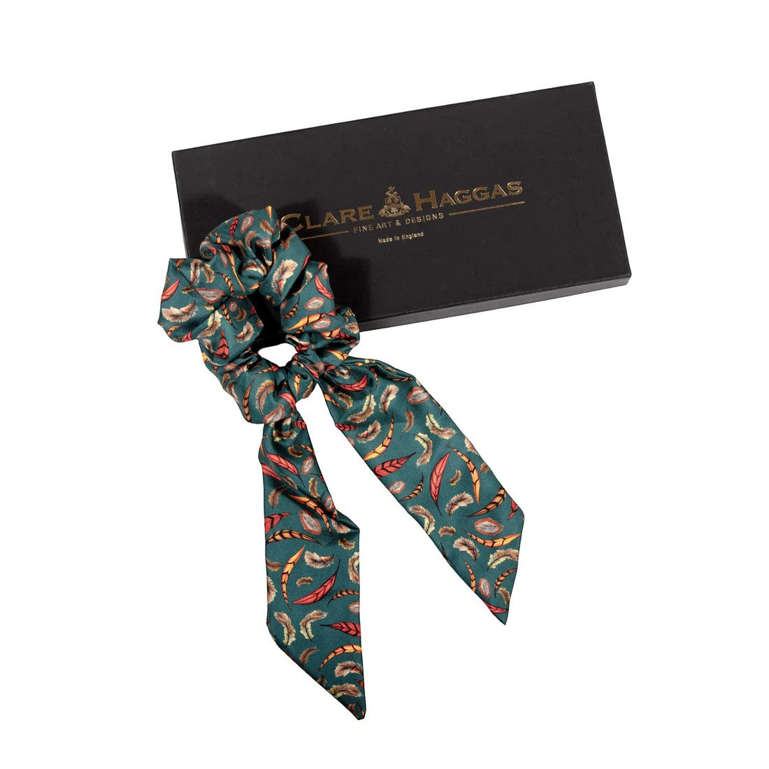 Patterned hair scrunchie with a black box featuring 'Clare Haggas' branding on a white background.