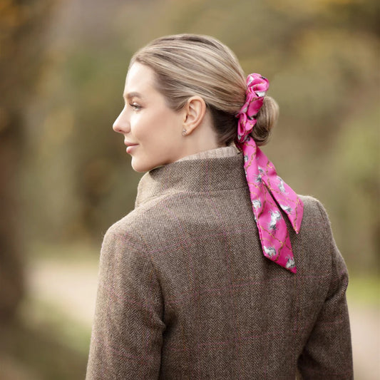 Woman wearing a pink hair scarf outdoors