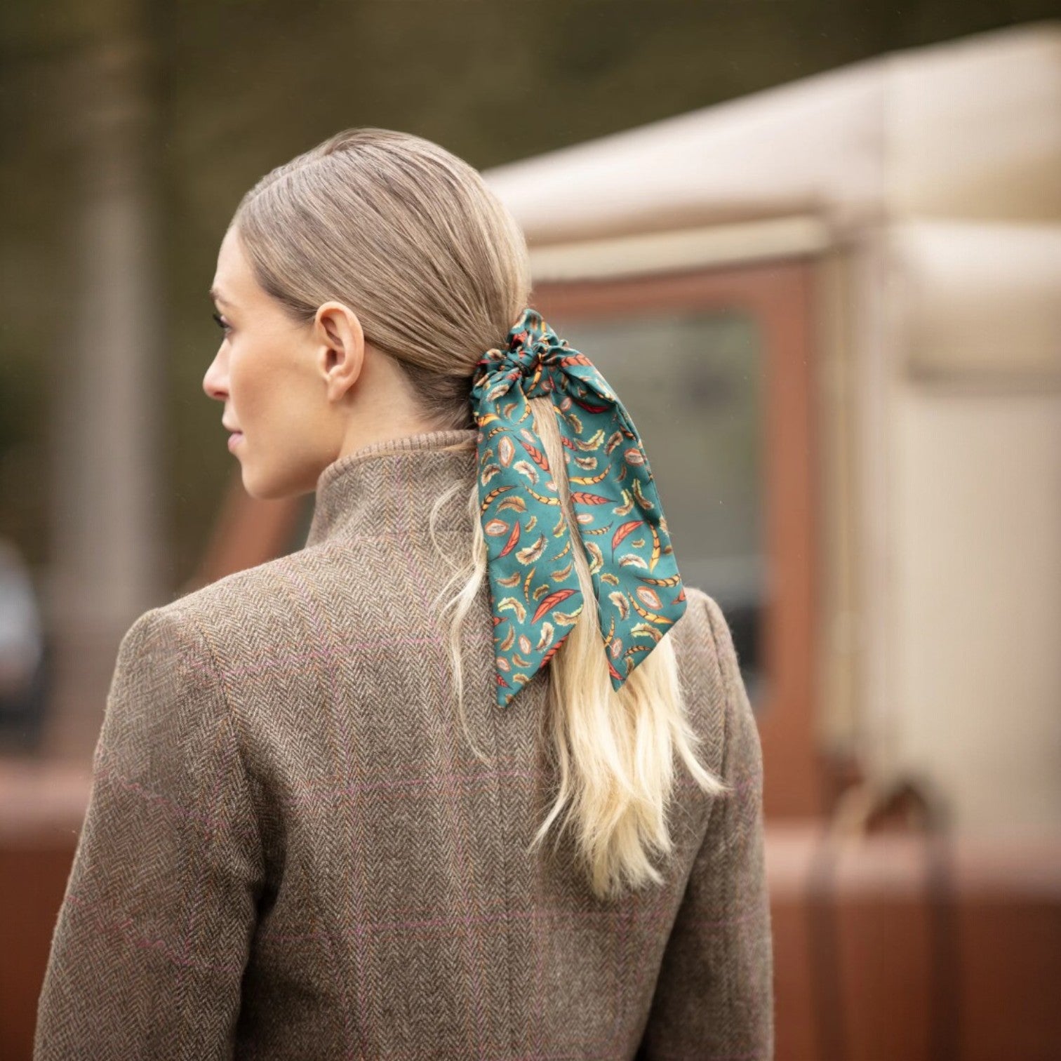 Woman with a patterned hair scarf in an urban setting