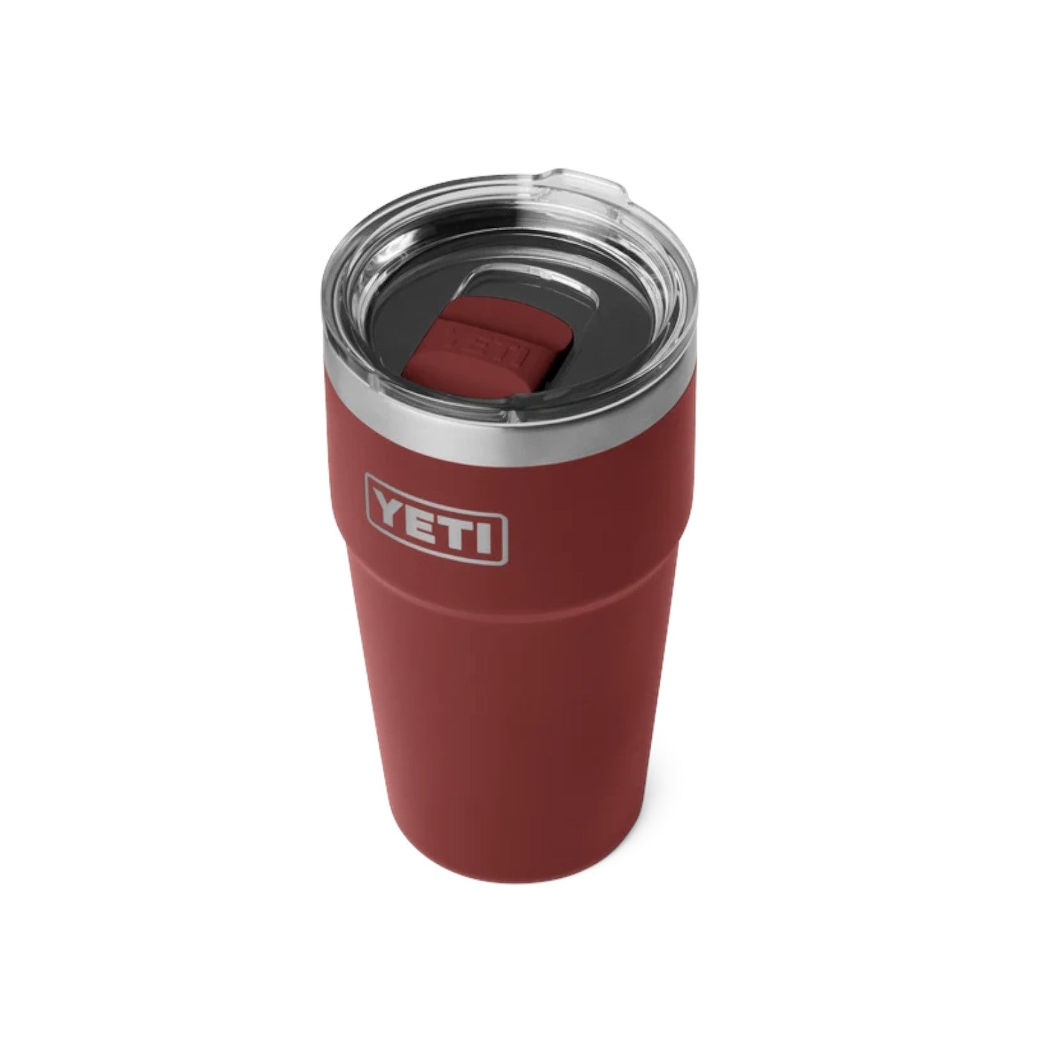 A YETI insulated travel tumbler in matte red, featuring a clear lid with a red silicone spill-resistant insert and a silver stainless steel rim. The YETI logo is clearly visible on the front of the cup.