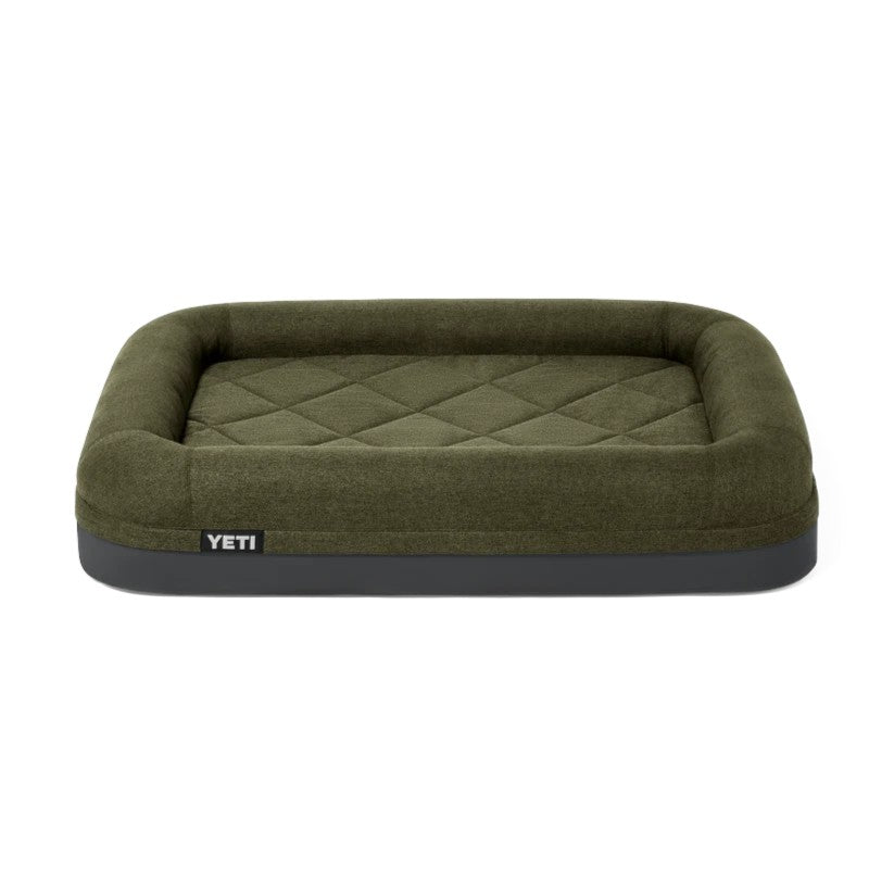 An olive green YETI pet bed with a diamond-quilted interior and a dark gray base, shown against a plain white background.