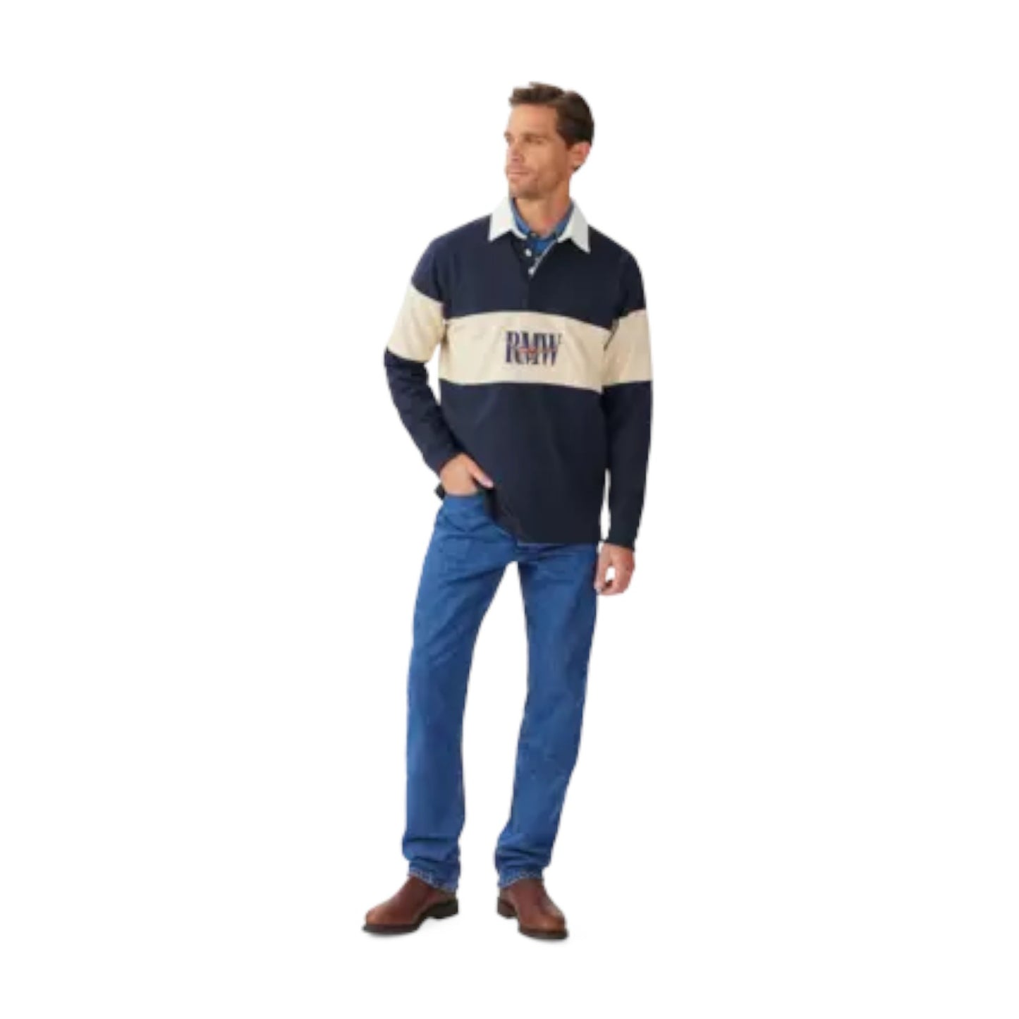 Man wearing a navy and beige rugby shirt with blue jeans on a white background