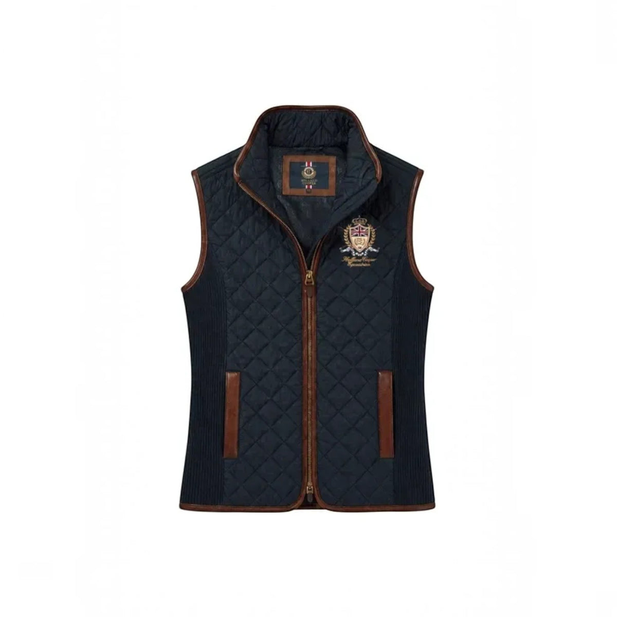 A navy blue quilted vest with brown trim and a zippered front, featuring a crest embroidered on the left chest. The brand label inside the collar reads 'Brixton'.