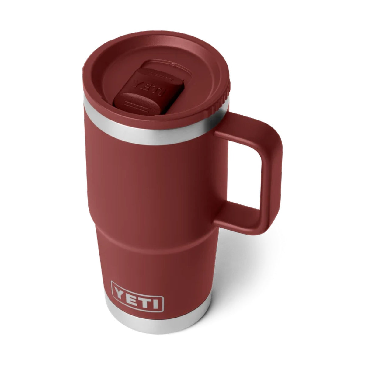 A YETI travel mug in a matte burgundy red color, featuring a stainless steel band around the middle and a matching stainless steel base. The mug has a built-in handle and a lid with a flip-up straw cover, shown on a clean white background.