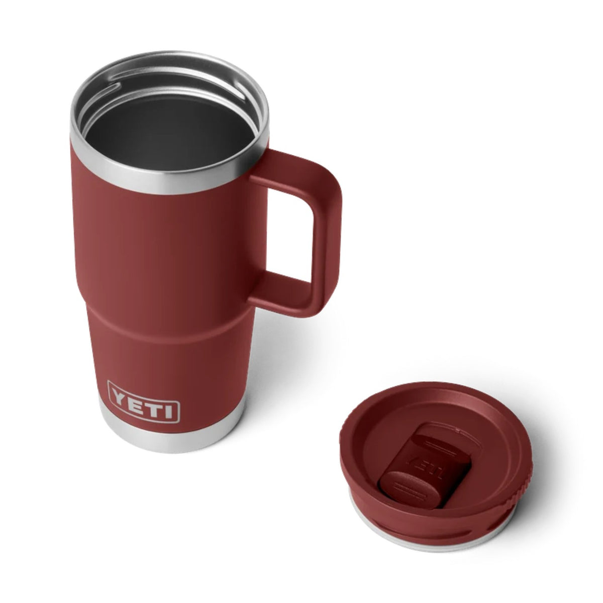 A YETI insulated travel mug in a deep red color with a stainless steel rim and base, shown alongside its matching red lid on a clean white background.