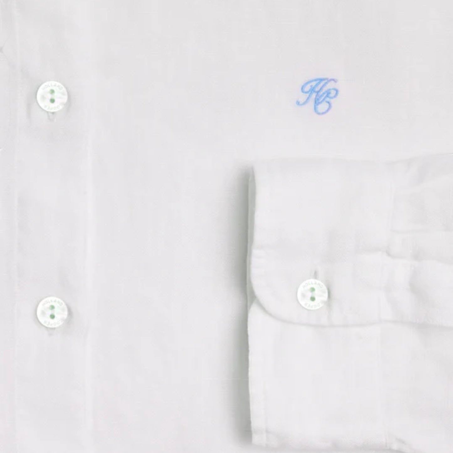 White dress shirt with monogram on a light gray background