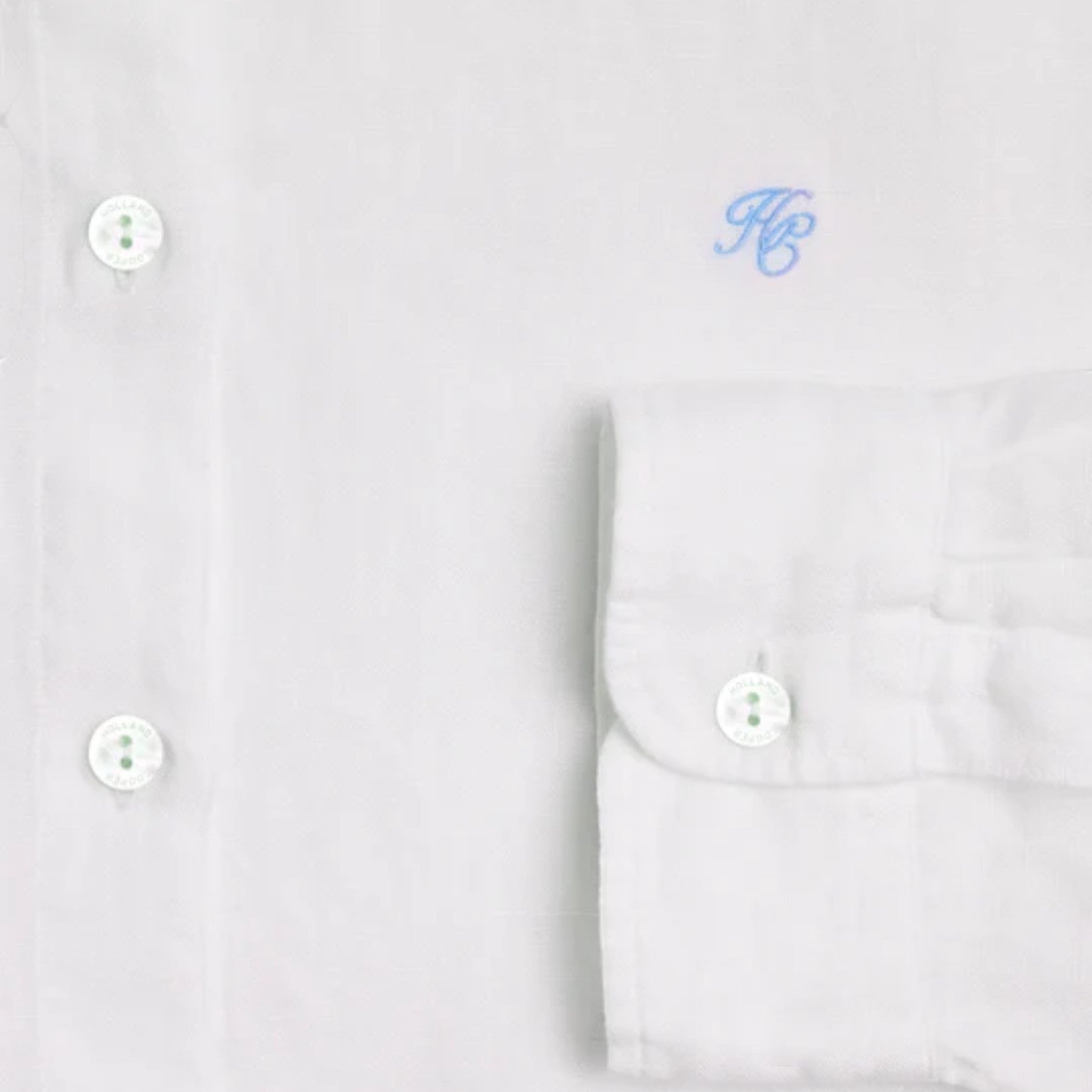 White dress shirt with monogram on a light gray background