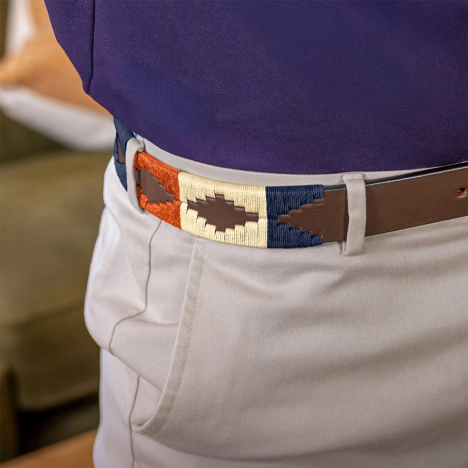 Person wearing a colorful belt with a blurred background