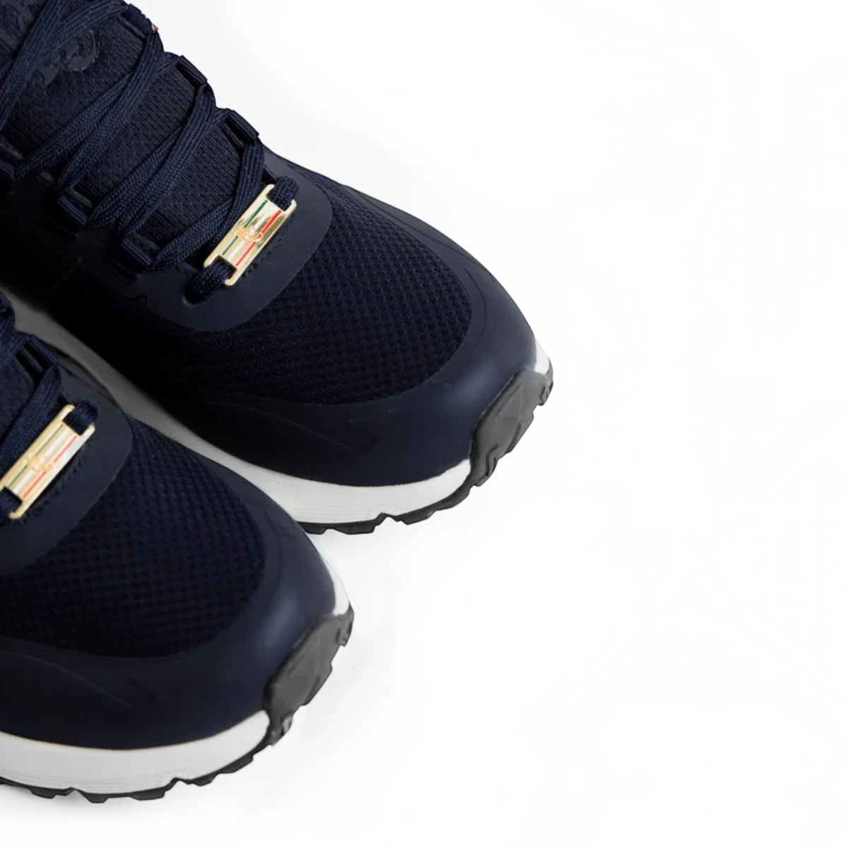 Close-up of a pair of dark navy blue athletic sneakers with metallic gold and multicolor accents on the laces, set against a plain white background.