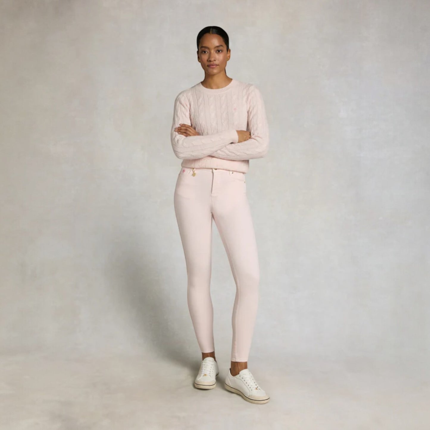 Person wearing a pink outfit with a plain background