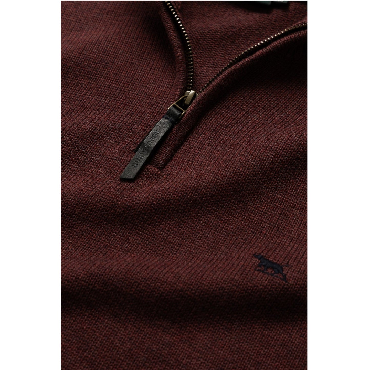 Close-up of a brown zip-up sweatshirt with a brand logo on a white background