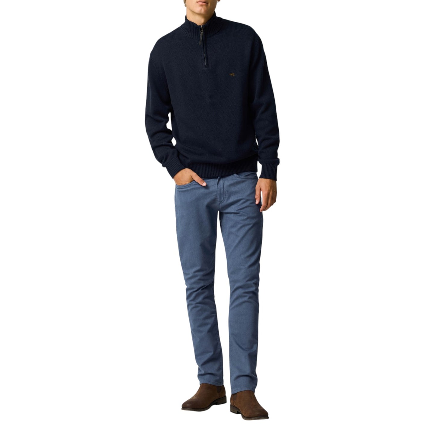 Man wearing a navy sweater and blue jeans on a white background