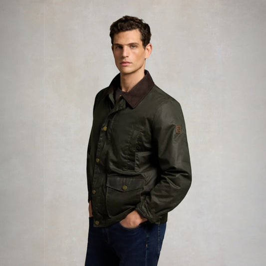 Man wearing a dark green jacket with a brown collar against a plain background