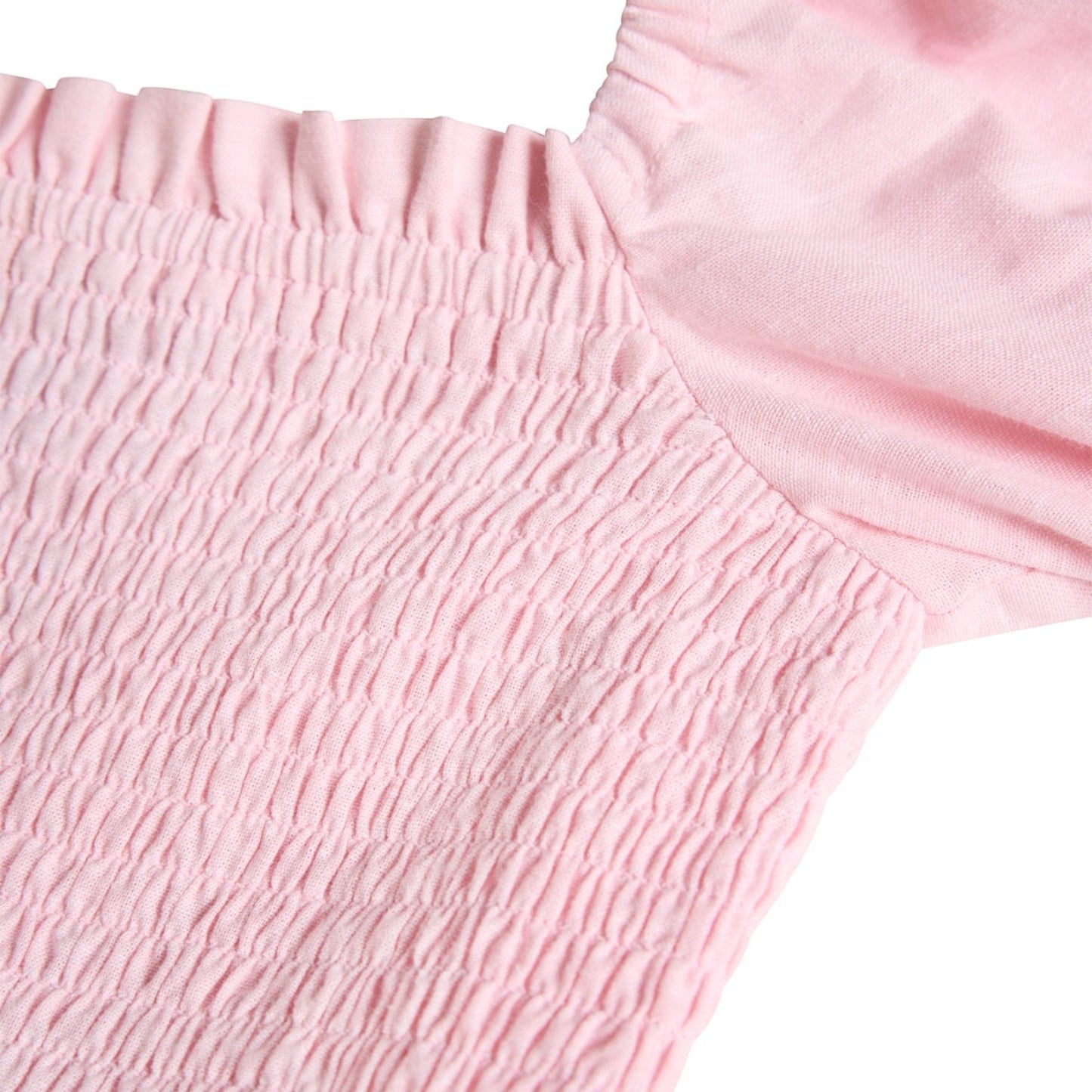 Close-up of pink textured fabric with a white background