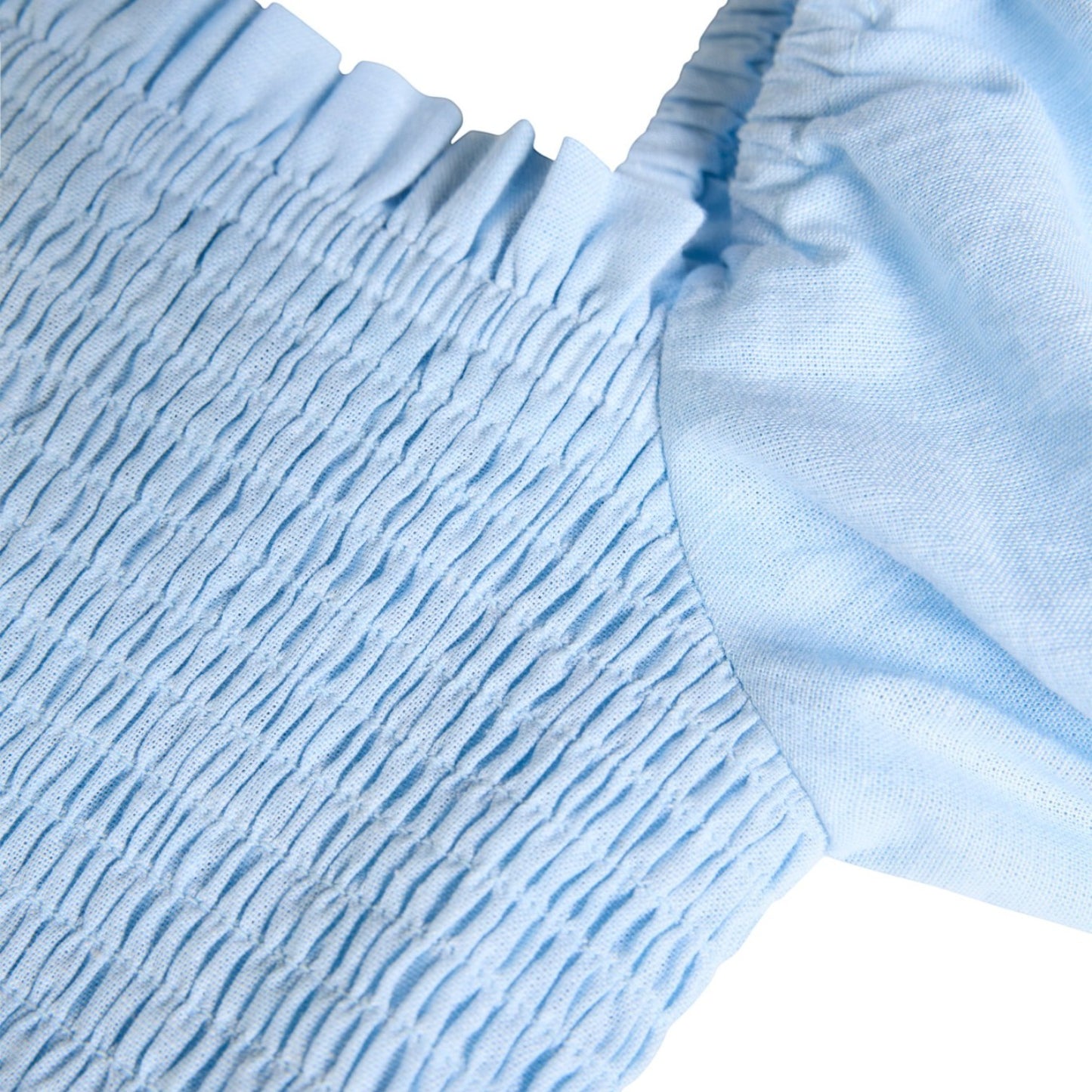 Close-up of light blue textured fabric with a white background