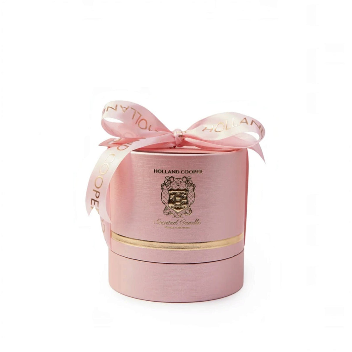 A pink cylindrical gift box for a scented candle by Holland Cooper, tied with a matching pink ribbon bow and gold lettering, on a white background.