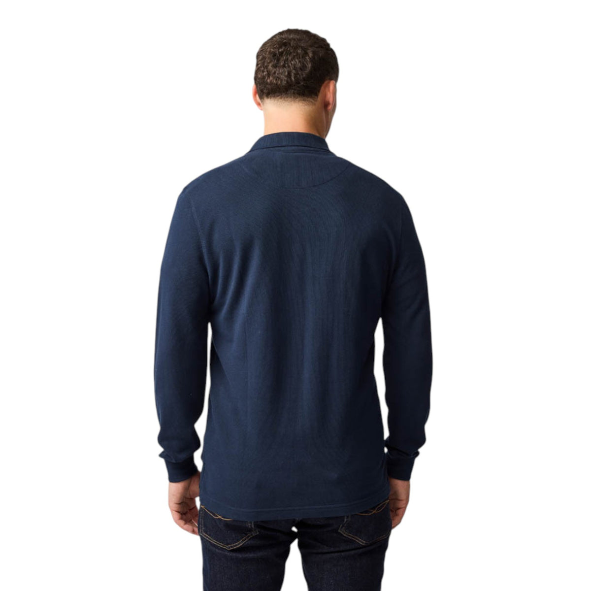 Man wearing a navy long-sleeve shirt on a white background