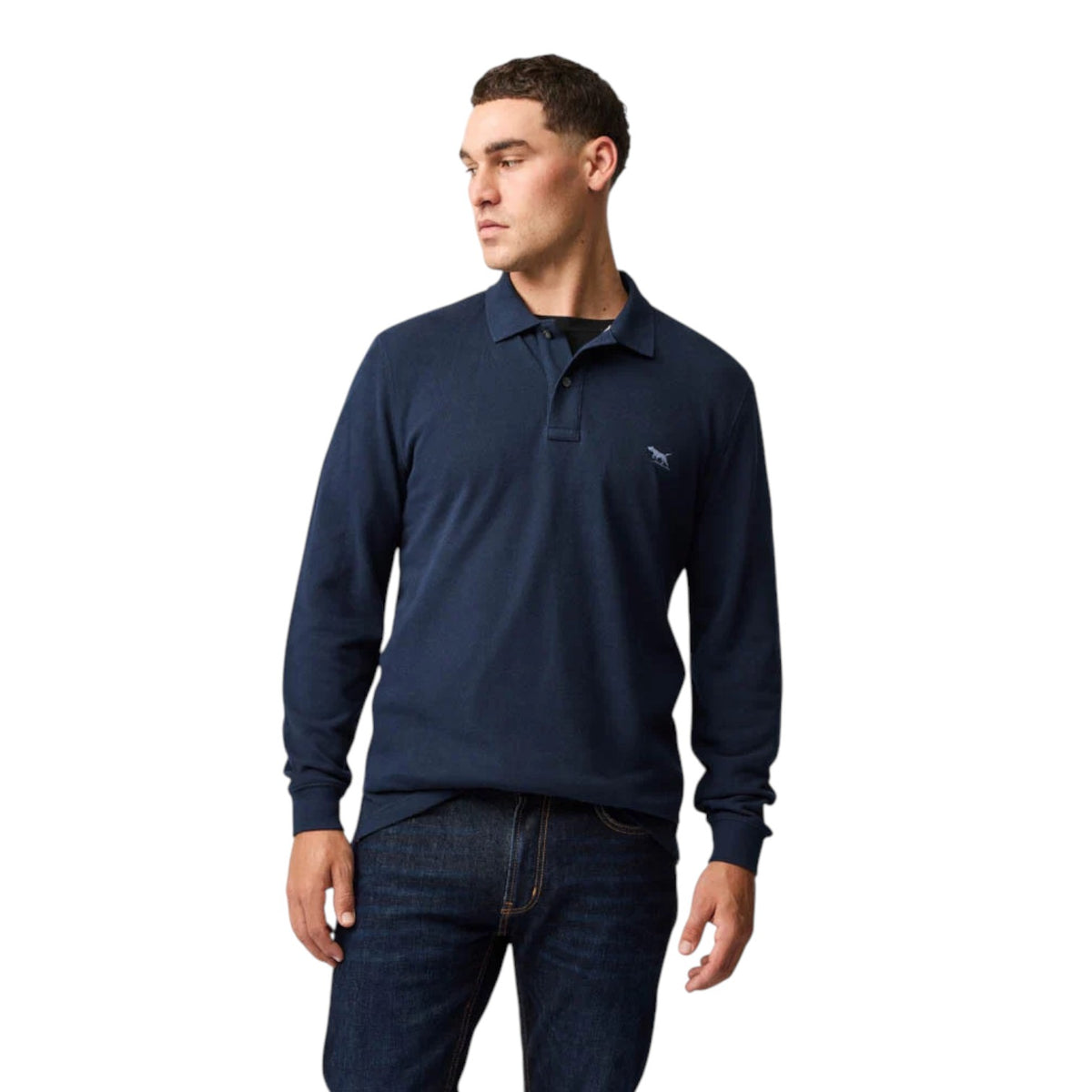 Man wearing a navy long-sleeve polo shirt and jeans on a white background
