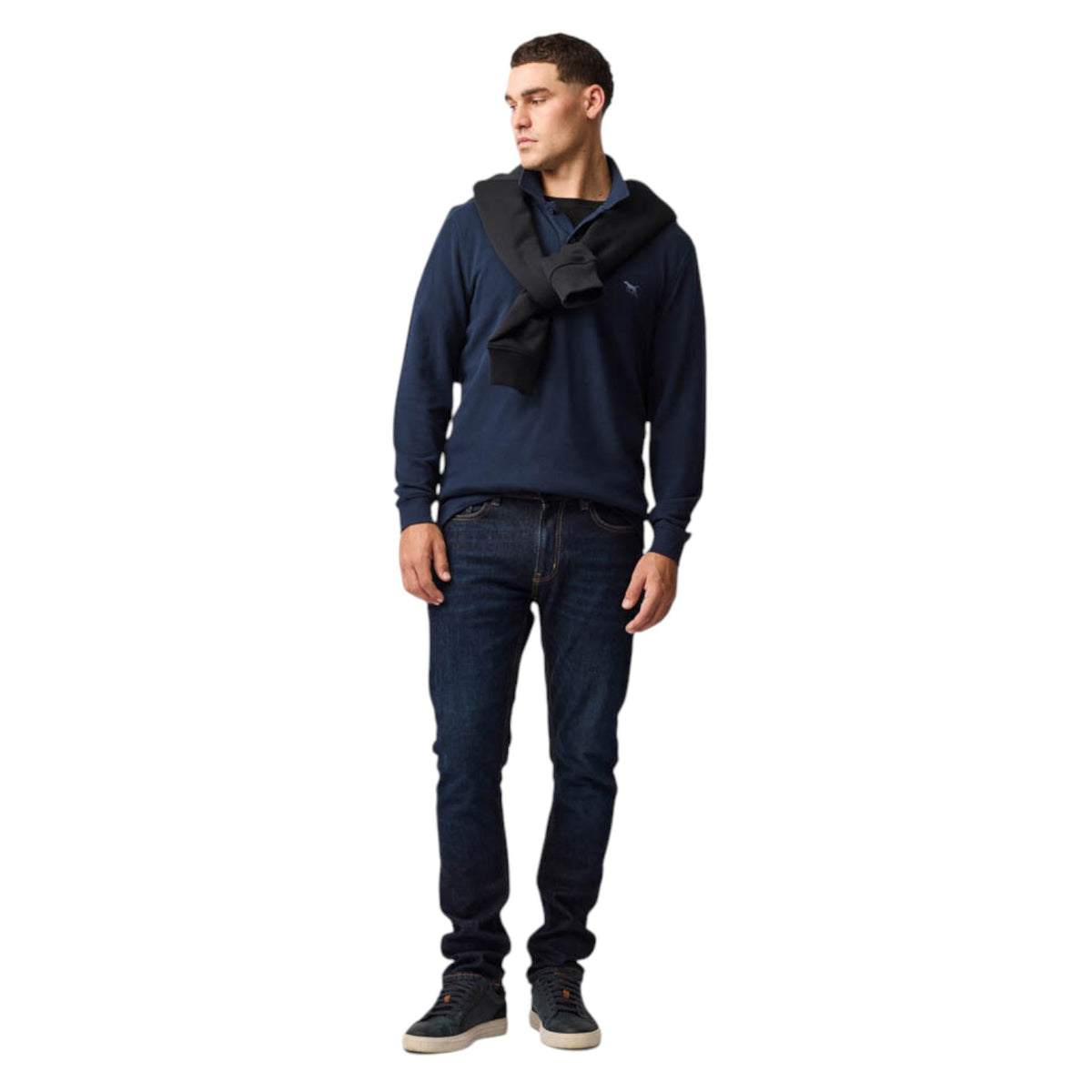 Man wearing a navy blue hoodie and jeans on a white background