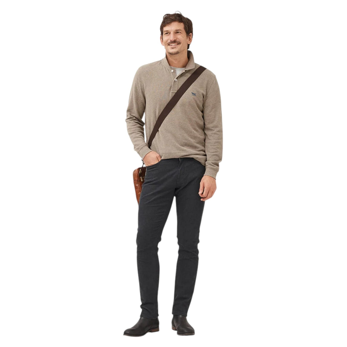 Man wearing a beige sweater and dark pants with a brown bag over his shoulder on a white background