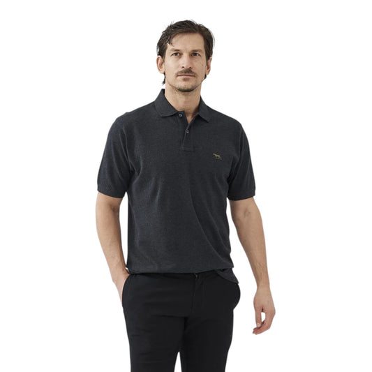 Man wearing a black polo shirt with a logo on a white background