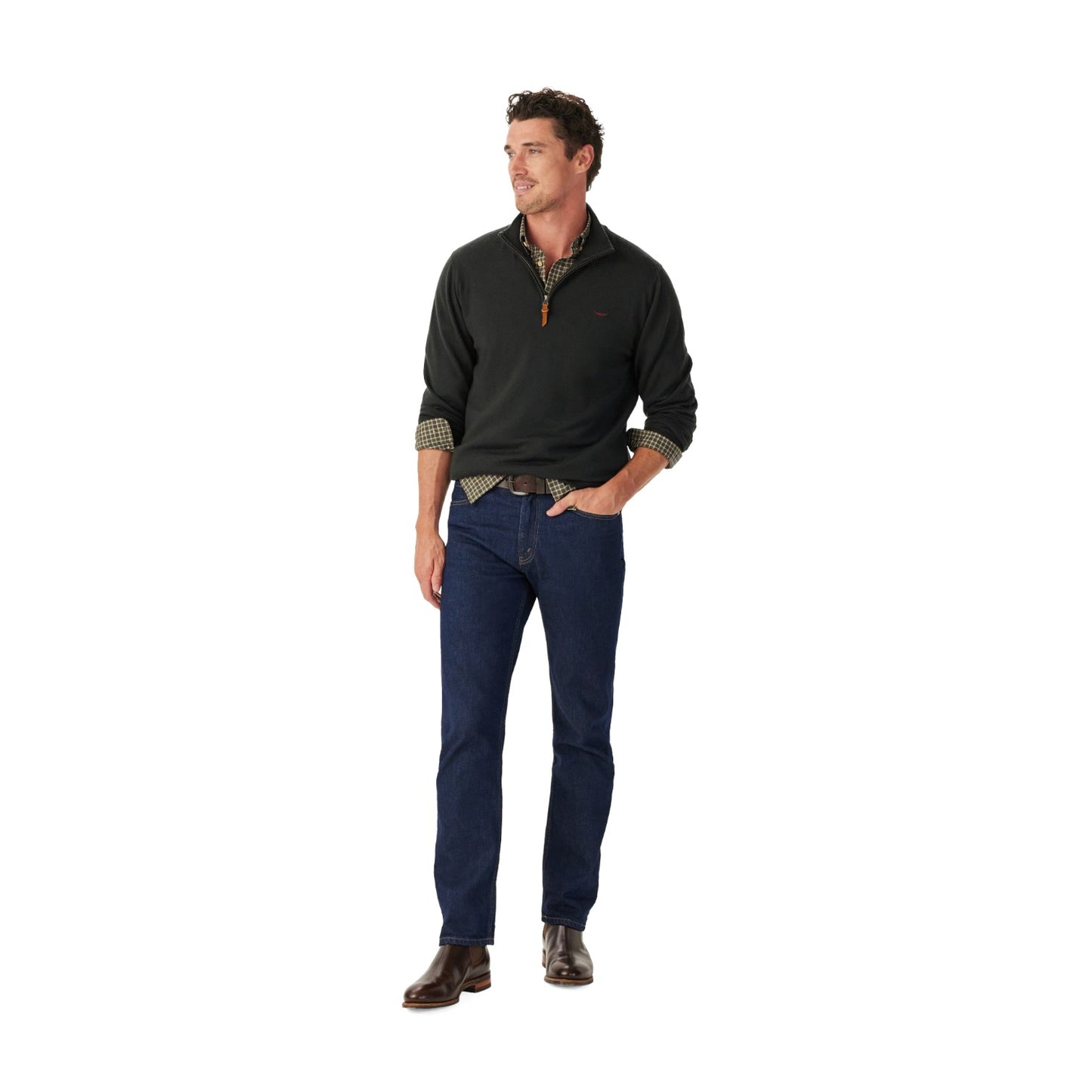 Man wearing a dark gray half-zip sweater and blue jeans on a white background