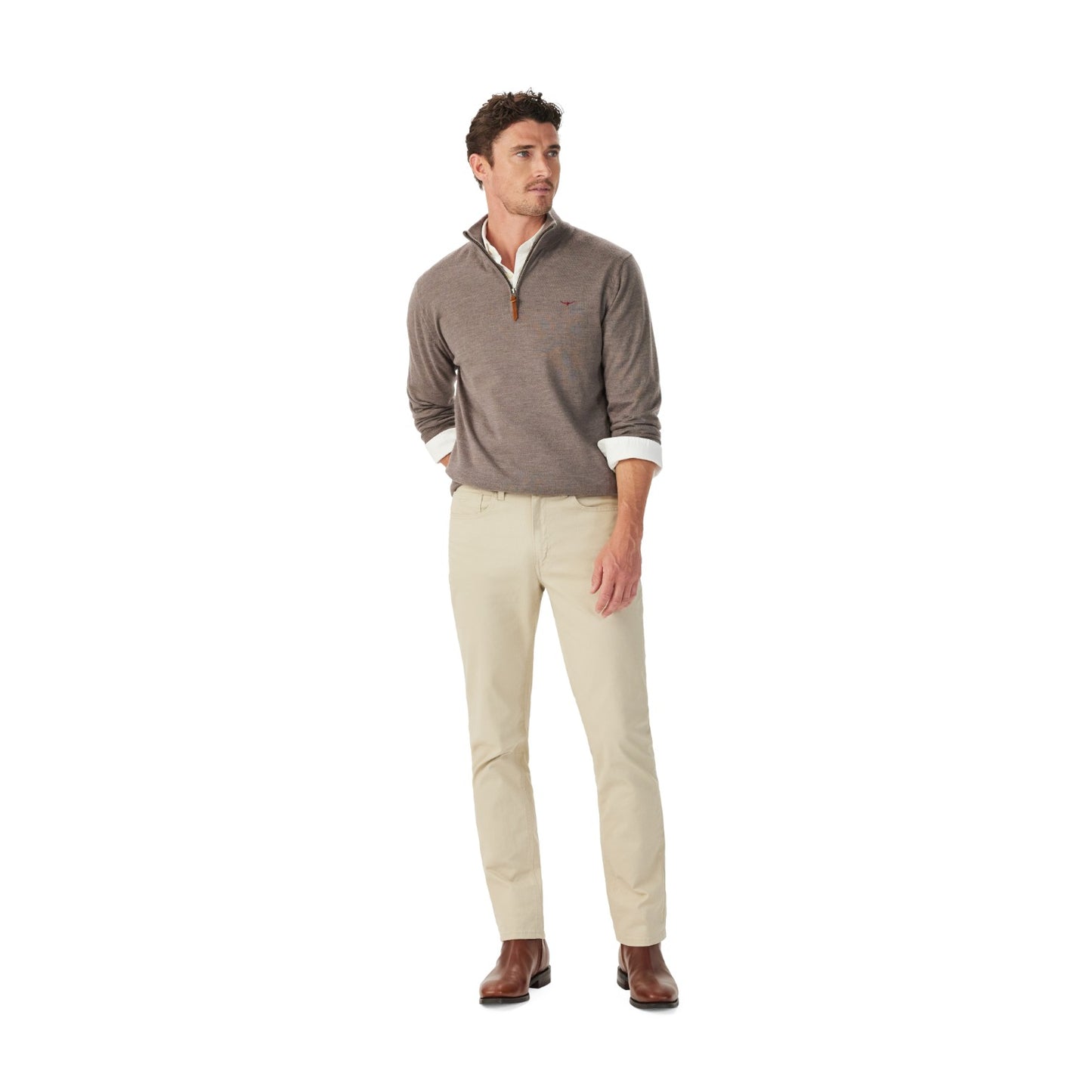 Man wearing a brown sweater and beige pants on a white background