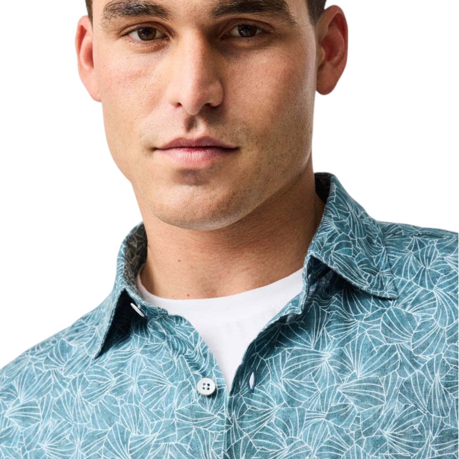 Man wearing a light blue patterned shirt on a white background