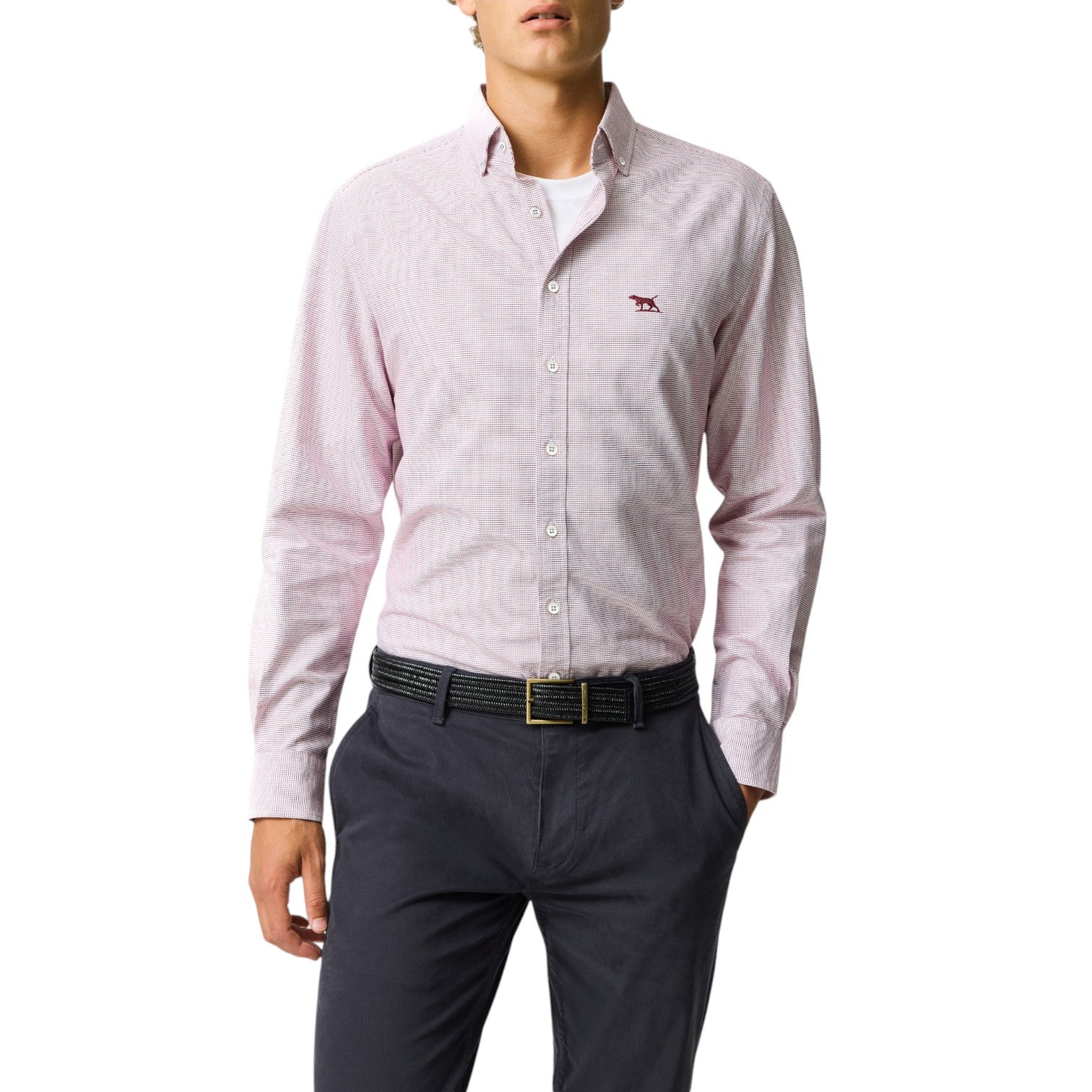Person wearing a light pink checkered shirt with a small logo on a white background