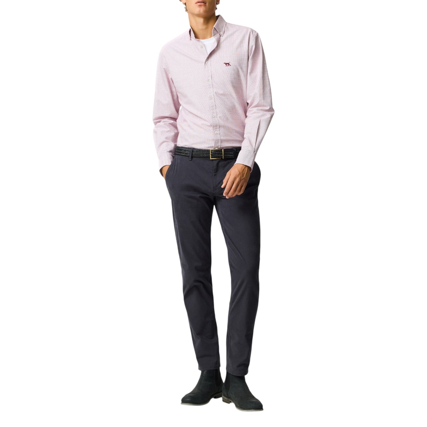Person wearing a pink dress shirt and dark pants on a white background