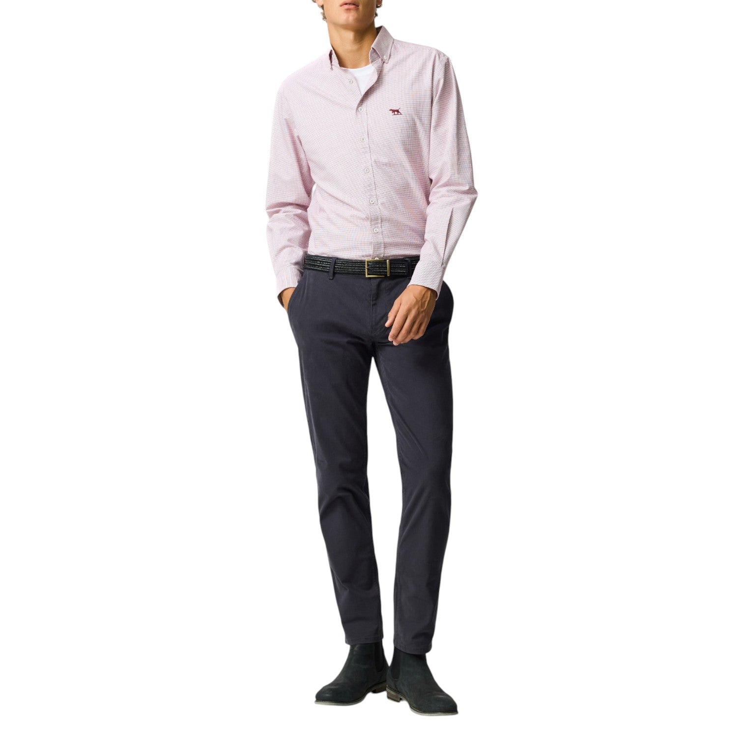 Person wearing a pink dress shirt and dark pants on a white background