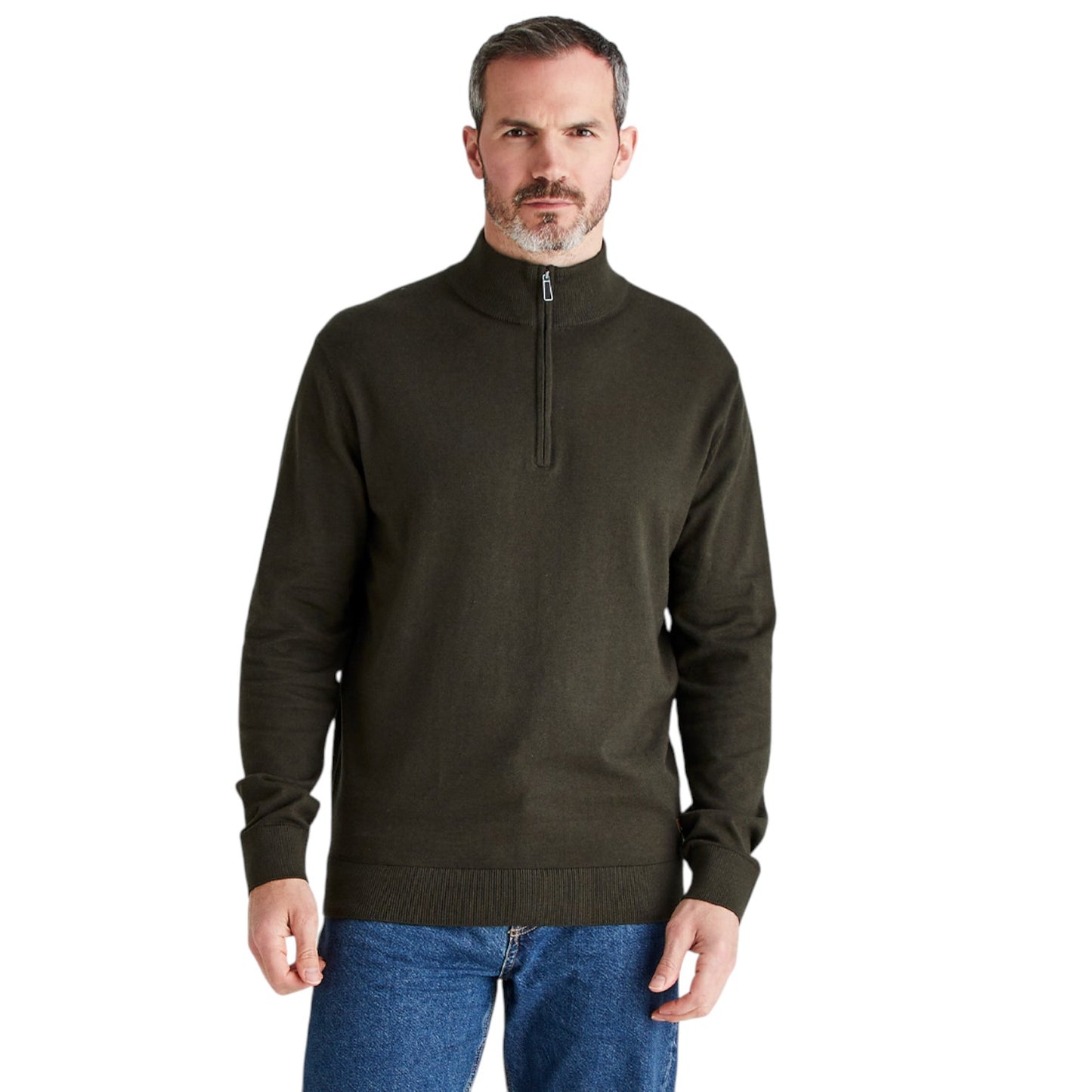 A man wearing a dark olive green quarter-zip knit sweater and blue jeans, standing against a plain white background.