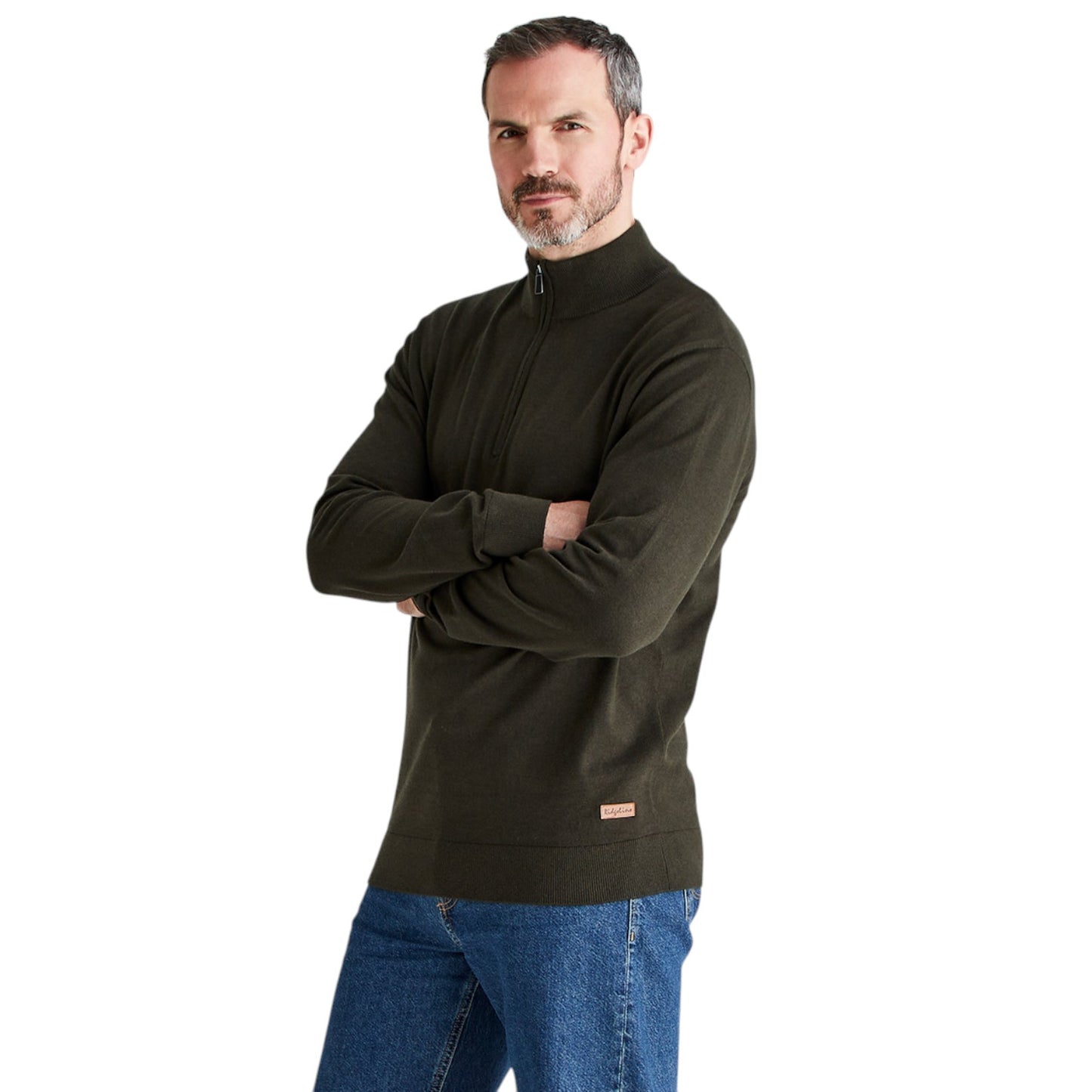A man wearing a dark olive green quarter-zip pullover sweater and blue jeans, standing with his arms crossed against a plain white background.