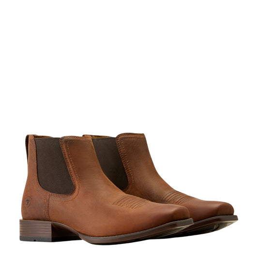 Pair of brown leather boots on a white background