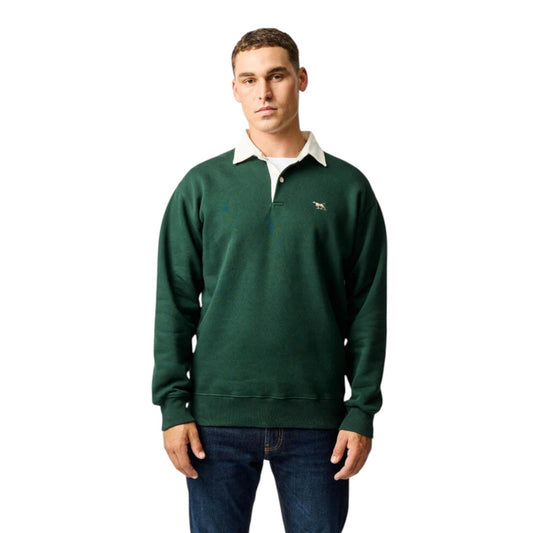 Man wearing a green sweater with a logo on a white background