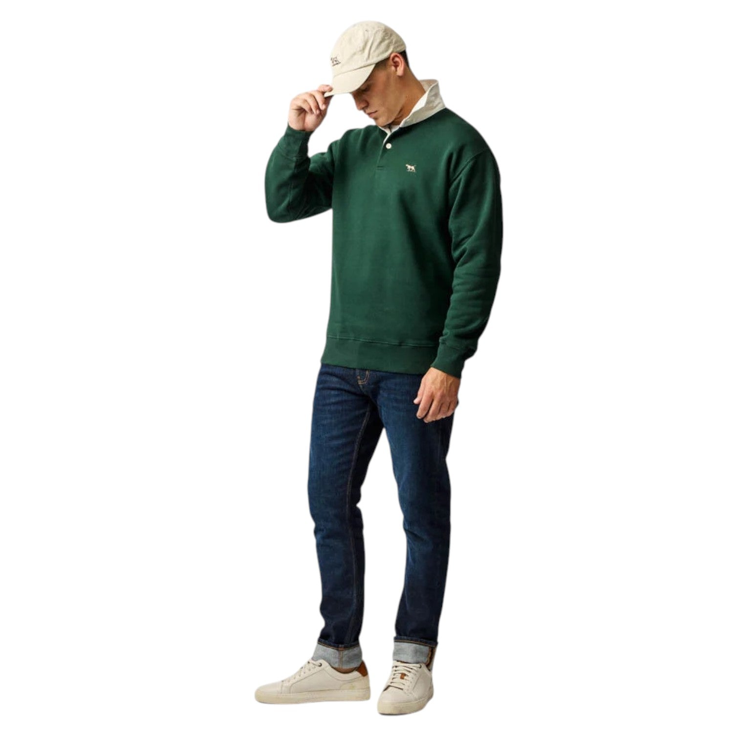Man wearing a green sweater, blue jeans, and white sneakers on a white background