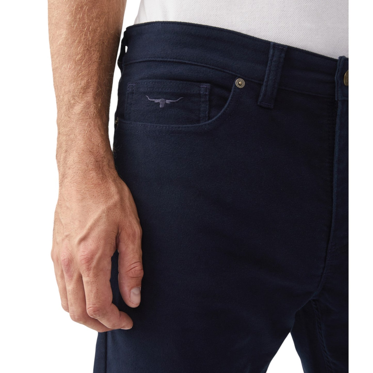 Navy blue jeans with a close-up of a pocket and a hand on a white background