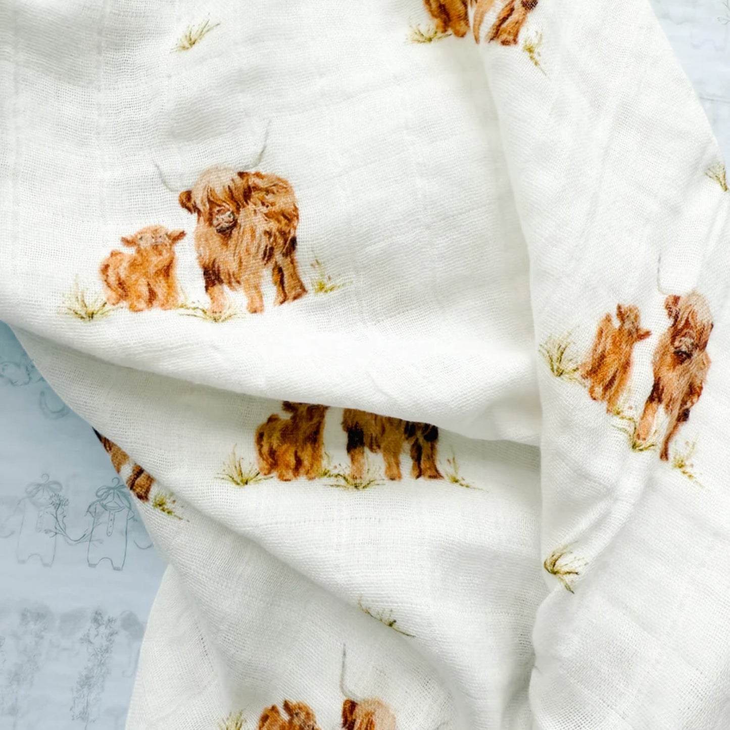 White fabric with brown dog print on a light blue background