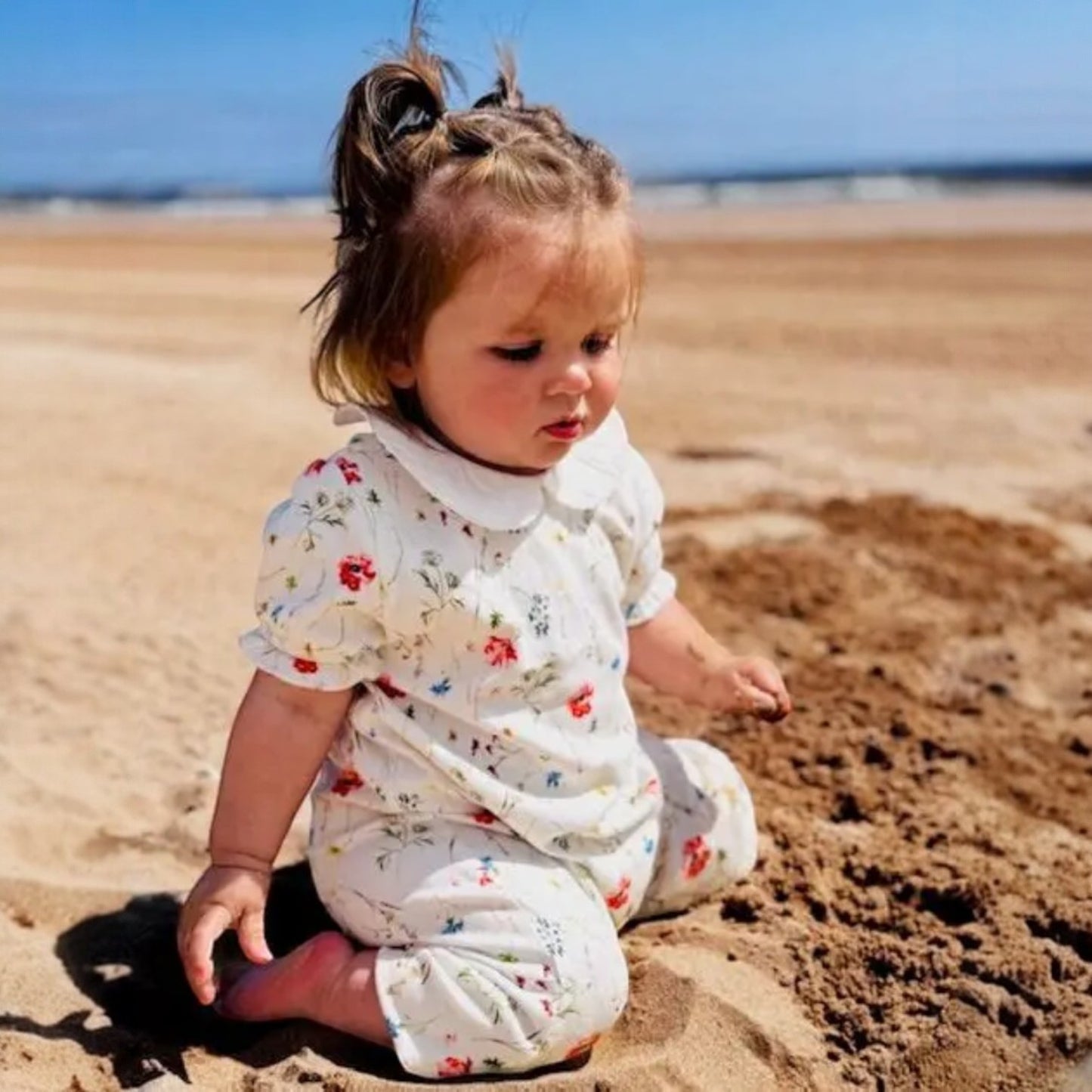 Child playing in the sand on a beach