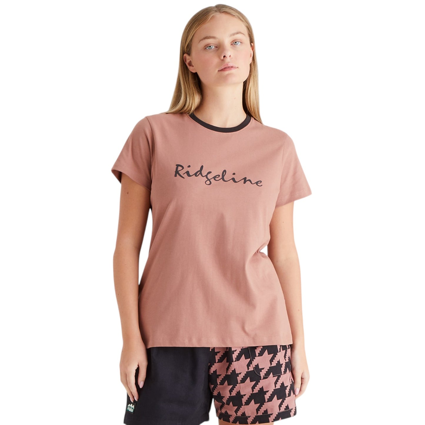 Woman wearing a pink t-shirt with 'Ridgeline' branding on a white background