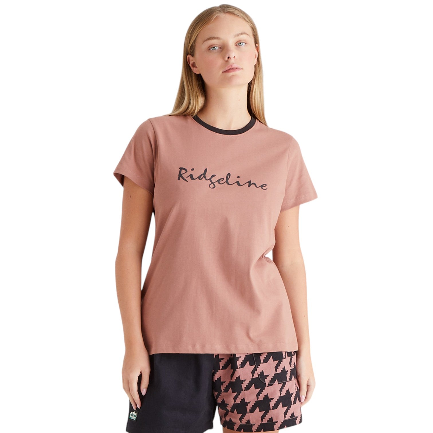 Woman wearing a pink t-shirt with 'Ridgeline' branding on a white background
