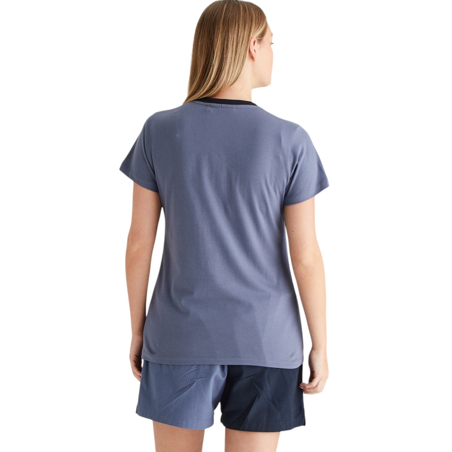 Person wearing a blue t-shirt and shorts set on a white background