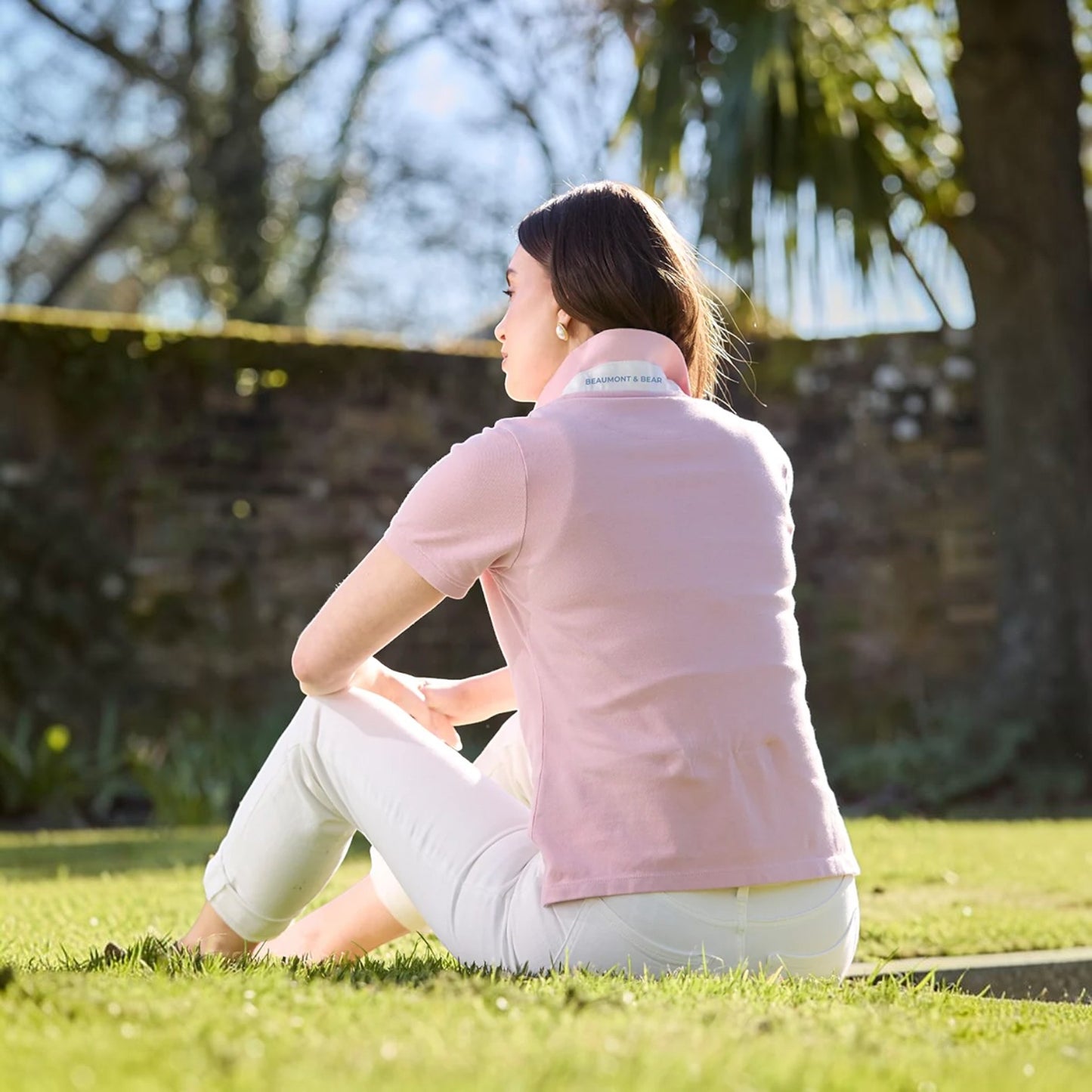 Woman sitting on grass in a park