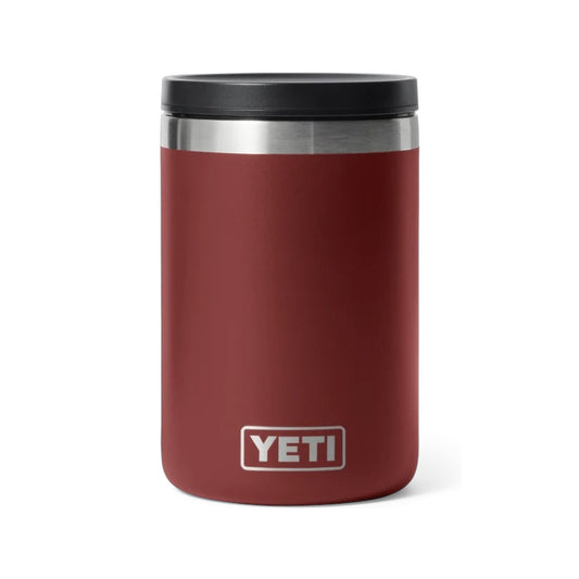 A YETI insulated tumbler in matte burgundy red with a black lid and a silver stainless steel band near the top, featuring the YETI logo on the front.