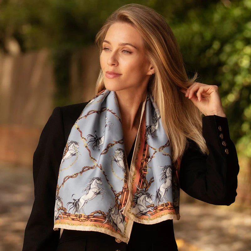 Woman wearing a patterned scarf outdoors with trees in the background