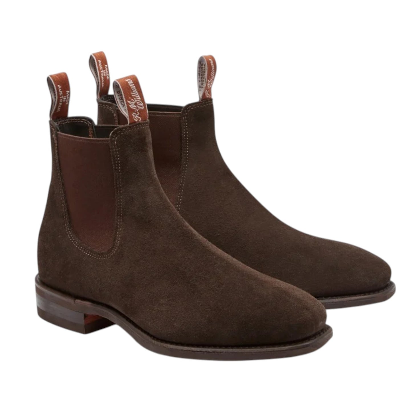A pair of dark brown suede Chelsea boots with elastic side panels and pull tabs, shown on a plain white background.