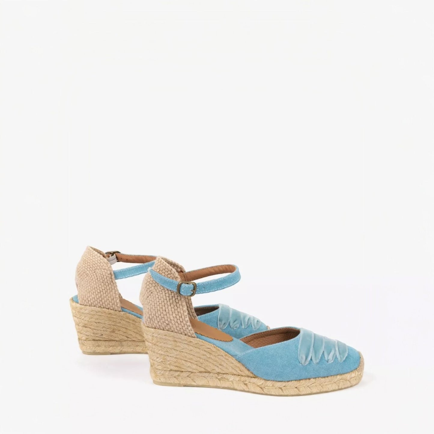 Blue wedge sandals with jute sole on a white background